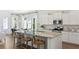Bright kitchen with white cabinets, stainless steel appliances, and large island with barstool seating at 297 Citrus Dr, Summerville, SC 29486