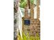 Elegant brick entrance featuring the property address, '3 Cross Lane,' amidst lush greenery at 3 Cross Ln, Isle of Palms, SC 29451