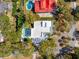 Aerial view of a luxury home features a red roof, private pool, and meticulously landscaped grounds at 3 Cross Ln, Isle of Palms, SC 29451