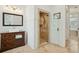Elegant bathroom featuring a walk-in shower with glass door and a classic vanity with vessel sink at 3 Cross Ln, Isle of Palms, SC 29451