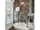 Stylish bathroom with a unique, vintage toilet and sink, complemented by dark, marbled tile walls at 3 Cross Ln, Isle of Palms, SC 29451