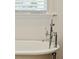 Close-up of a freestanding bathtub with chrome fixtures and natural light, highlighting the bathroom's elegance at 3 Cross Ln, Isle of Palms, SC 29451