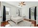 Bright bedroom with hardwood floors, ceiling fan, and large windows for natural light at 3 Cross Ln, Isle of Palms, SC 29451