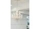 Close up of an ornate crystal chandelier and white trim in the home's interior at 3 Cross Ln, Isle of Palms, SC 29451