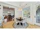 Dining area with round table and chairs, chandelier, and a view to the living room at 3 Cross Ln, Isle of Palms, SC 29451