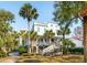 Stunning coastal home with multiple balconies, a welcoming front porch, and lush palm trees creating a tropical paradise at 3 Cross Ln, Isle of Palms, SC 29451