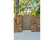 Charming pineapple-adorned wooden gate between brick walls creates a welcoming entrance at 3 Cross Ln, Isle of Palms, SC 29451