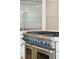 Close-up of a stainless steel stove with blue knobs, situated within a well-appointed kitchen at 3 Cross Ln, Isle of Palms, SC 29451