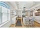 Modern kitchen with marble countertops, stainless appliances, island, and bar stool seating at 3 Cross Ln, Isle of Palms, SC 29451