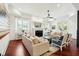 Spacious living room with fireplace, hardwood floors, neutral colored sofas, and bright, natural light at 3 Cross Ln, Isle of Palms, SC 29451