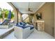 Covered outdoor lounge with wicker seating, brick counter, and a TV, perfect for relaxation and entertainment at 3 Cross Ln, Isle of Palms, SC 29451
