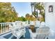 Inviting outdoor seating area on the balcony, complete with white Adirondack chairs and a cozy fire pit at 3 Cross Ln, Isle of Palms, SC 29451