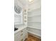 Pantry with built in shelves and drawers, featuring a countertop, a window with blinds and decorative plates at 3 Cross Ln, Isle of Palms, SC 29451