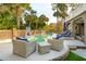 A backyard pool surrounded by palm trees, lounge chairs, and wicker furniture invites relaxation and entertainment at 3 Cross Ln, Isle of Palms, SC 29451
