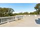 Expansive rooftop deck with balustrade overlooking lush greenery and providing ample outdoor living space at 3 Cross Ln, Isle of Palms, SC 29451