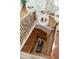 Grand staircase featuring wood steps, ornate iron railings, and a chandelier overhead at 3 Cross Ln, Isle of Palms, SC 29451