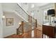 Bright foyer with a wooden staircase, complemented by large windows and a decorative art piece at 3 Cross Ln, Isle of Palms, SC 29451