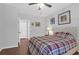 This bedroom features a comfortable bed with a plaid comforter, wood flooring, and neutral wall paint at 300 Bucksley Ln # 104, Charleston, SC 29492