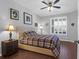Cozy bedroom with a plaid comforter, ceiling fan, wood flooring and natural light from the window at 300 Bucksley Ln # 104, Charleston, SC 29492