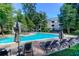 Community pool area featuring lounge chairs and shade, perfect for relaxation at 300 Bucksley Ln # 104, Charleston, SC 29492