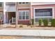 Charming condo exterior with red and yellow siding, white trim, and manicured landscaping at 300 Bucksley Ln # 104, Charleston, SC 29492