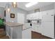 Bright kitchen features white cabinetry, modern appliances, and a stylish breakfast bar at 300 Bucksley Ln # 104, Charleston, SC 29492