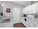 Bright kitchen boasts white cabinetry, modern appliances, and an adjoining breakfast bar for casual dining at 300 Bucksley Ln # 104, Charleston, SC 29492