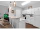 Bright kitchen features white cabinetry, pendant lighting, modern appliances, and seating at the breakfast bar at 300 Bucksley Ln # 104, Charleston, SC 29492