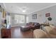 Bright living room features hardwood floors, comfortable seating, and a large window at 300 Bucksley Ln # 104, Charleston, SC 29492