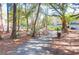 Serene walking path through lush trees and landscaping within the community at 300 Bucksley Ln # 104, Charleston, SC 29492