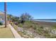Peaceful backyard featuring a wooden walkway, verdant plants, and serene views of the marshland and waterway at 3034 Bell Cv Aly, Johns Island, SC 29455