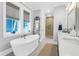 Bright bathroom featuring soaking tub, walk-in shower, gray accents, and modern fixtures at 3034 Bell Cv Aly, Johns Island, SC 29455