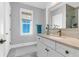 Bright bathroom features a window, framed mirror, vanity, and bronze fixtures at 3034 Bell Cv Aly, Johns Island, SC 29455