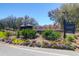 Welcome to the community, marked by a sign surrounded by a beautiful garden and lush landscaping at 3034 Bell Cv Aly, Johns Island, SC 29455