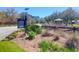 Welcome to the community, marked by a beautifully landscaped sign with colorful flowers and lush greenery at 3034 Bell Cv Aly, Johns Island, SC 29455
