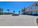 Expansive view of a charming community with white buildings, palm trees, and a beautifully landscaped center at 3034 Bell Cv Aly, Johns Island, SC 29455