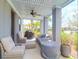 Covered patio featuring comfortable seating, ceiling fan, and grill for outdoor entertainment at 3034 Bell Cv Aly, Johns Island, SC 29455