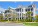 Three-story homes featuring charming screened-in porches and tropical landscaping at 3034 Bell Cv Aly, Johns Island, SC 29455