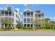 Three-story homes with screened-in porches and lovely tropical landscaping at 3034 Bell Cv Aly, Johns Island, SC 29455