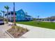 Inviting exterior of a multi-story home with a spacious lawn, complemented by tropical palm trees and ample parking at 3034 Bell Cv Aly, Johns Island, SC 29455