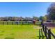 Expansive fenced pasture with shelters and barns offering a versatile space for rural pursuits at 3034 Bell Cv Aly, Johns Island, SC 29455