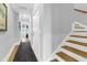 Bright hallway featuring a staircase with white risers and wood treads plus an area rug at 3034 Bell Cv Aly, Johns Island, SC 29455