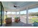 Screened porch with a fan, comfortable seating, and a nice view of the neighborhood and trees at 3034 Bell Cv Aly, Johns Island, SC 29455