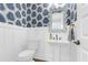 Stylish powder room features bold wallpaper and a decorative mirror at 3034 Bell Cv Aly, Johns Island, SC 29455