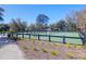 Enjoy a match on this outdoor tennis court with a pristine green surface and lovely wooded surroundings at 3034 Bell Cv Aly, Johns Island, SC 29455