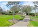Picturesque walking path meanders through lush landscaping and beautiful trees on a sunny day at 3034 Bell Cv Aly, Johns Island, SC 29455