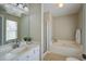 Bathroom with a separate tub, a vanity with drawers, and a glass-enclosed shower at 309 Edinburgh St, Summerville, SC 29483