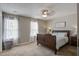 Inviting bedroom with two windows, a wooden bed frame, carpet, and soft lighting at 309 Edinburgh St, Summerville, SC 29483