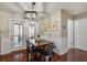 Dining area with dark hardwood floors, modern lighting, dining table, and adjacent patio access at 309 Edinburgh St, Summerville, SC 29483