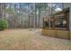 Home features a wooden deck and landscaped backyard with a stone fire pit and mature trees at 309 Edinburgh St, Summerville, SC 29483